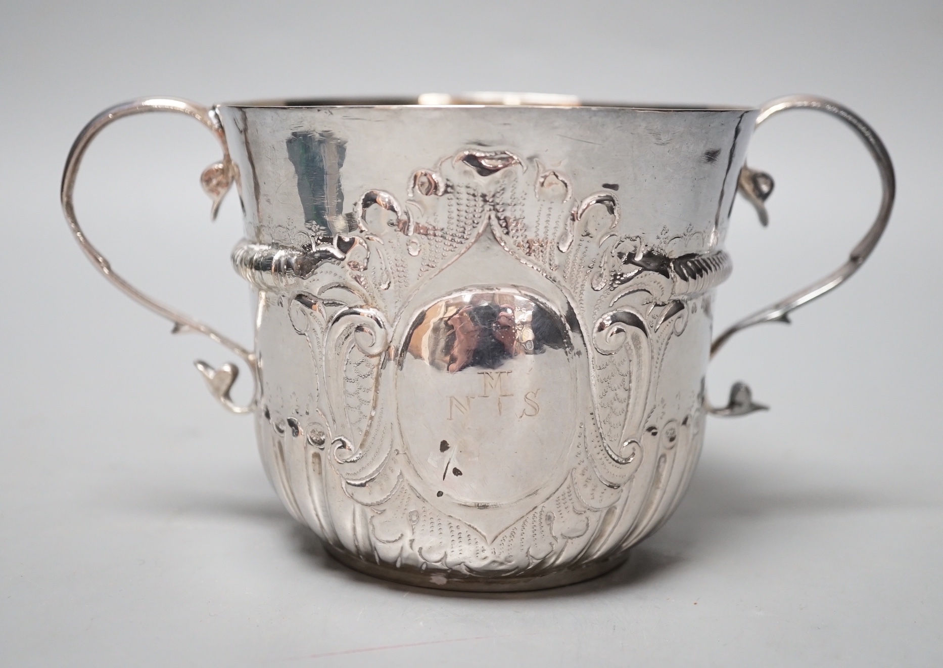 A George I embossed silver porringer, by Thomas Fort, London, 1714, height 91mm, 198 grams, (repairs).